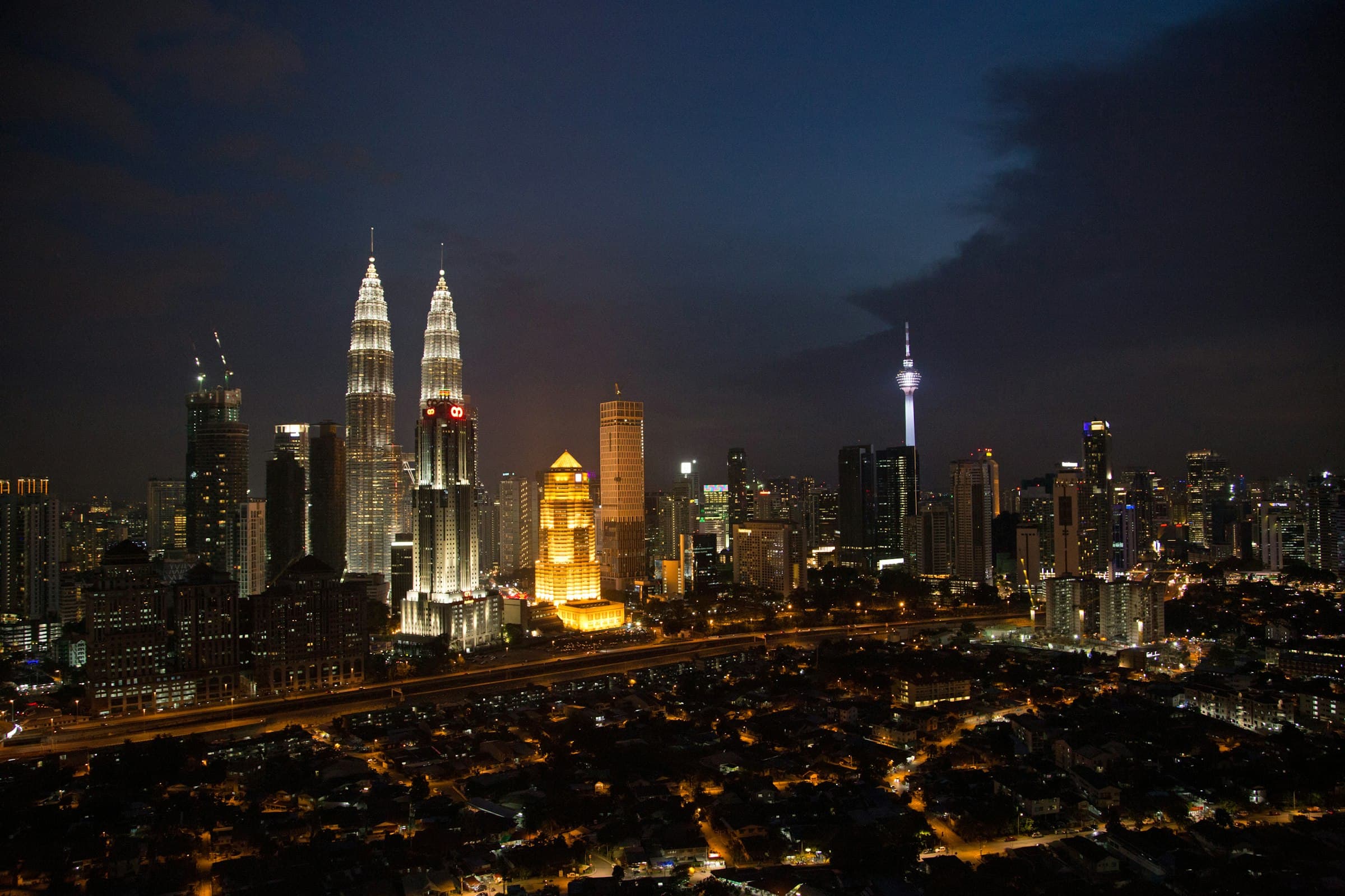 Kuala Lumpur skyline at night with the Petronas Twin Towers