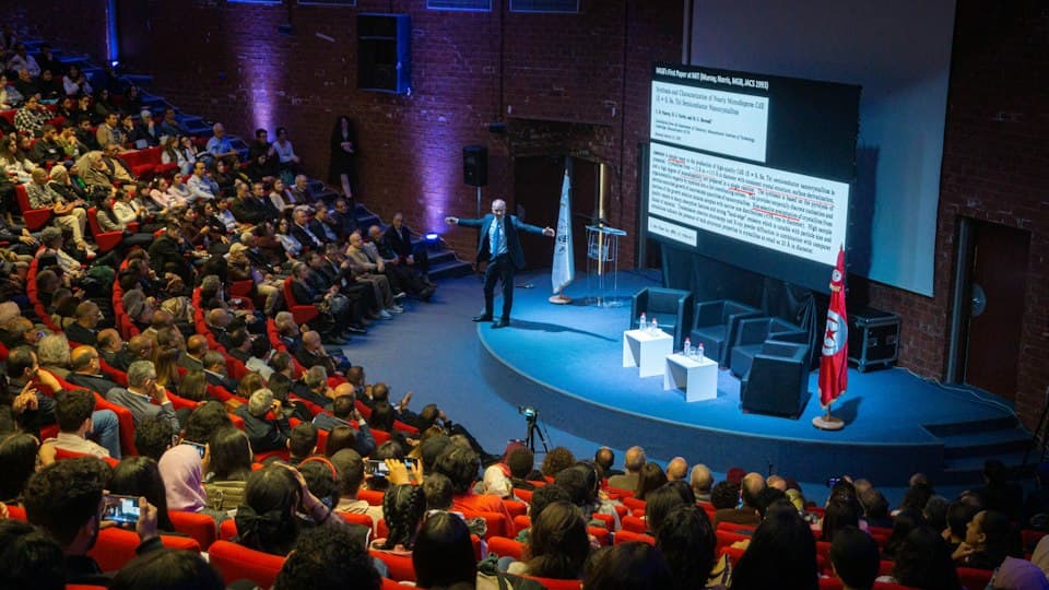Speaker presenting to a conference audience